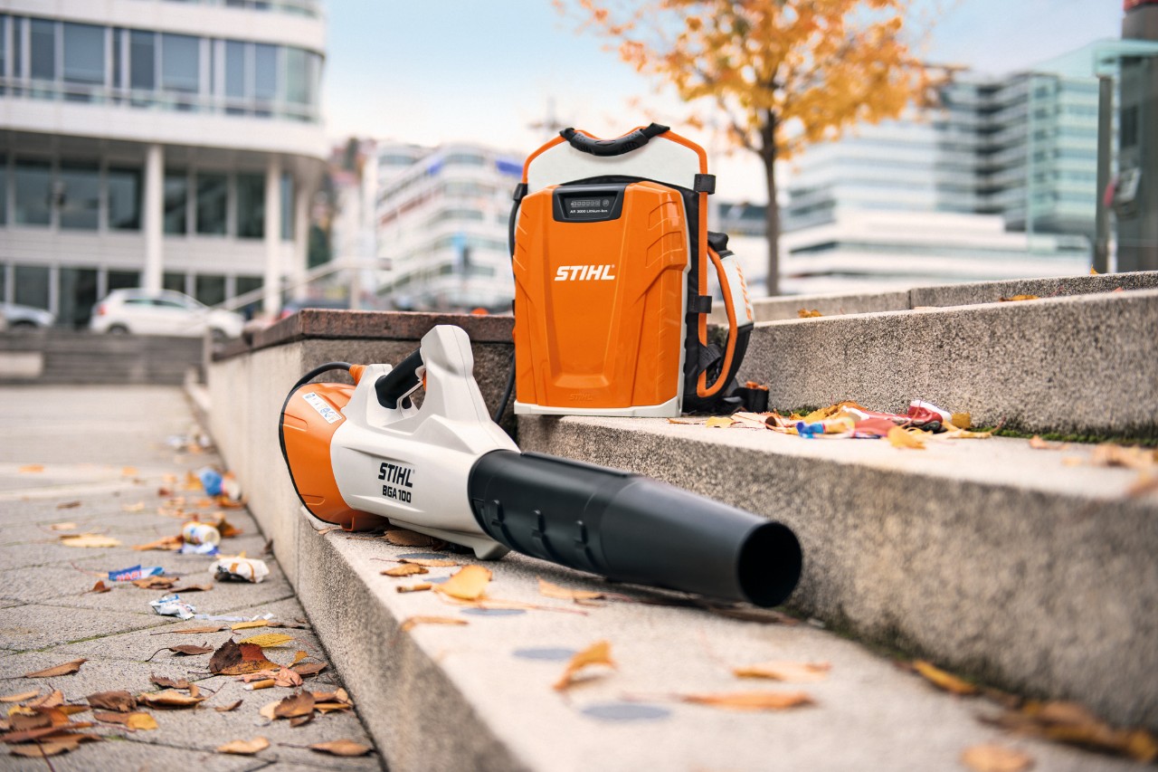 落ち葉が積もった石階段の上に横たわるバッテリブロワーSTIHL BGA 100と背負式プロフェッショナルバッテリーSTIHL AR 3000 L